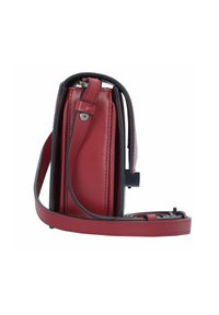 Red leather crossbody bag with a slim profile, smooth texture, and black strap. Features a top handle and a small clasp detail.