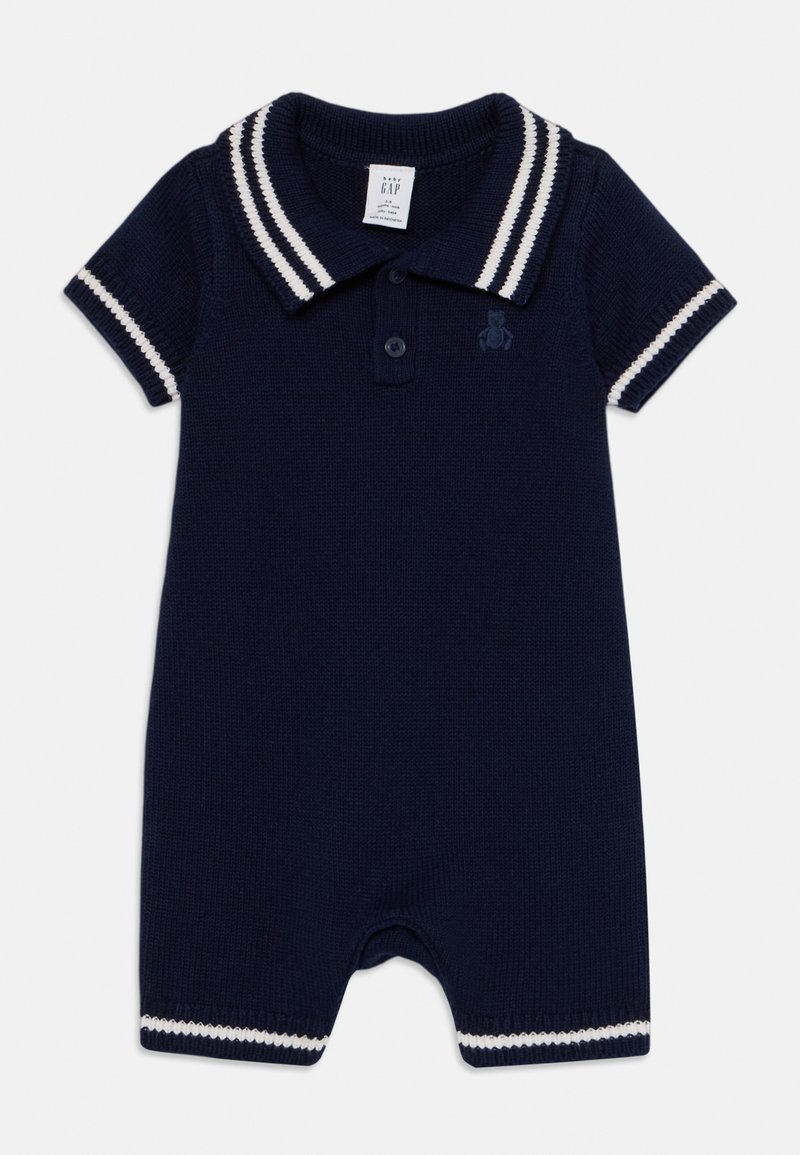 Tumed sinise värvi lühikeste varrukatega romper, millel on kudumisstruktuur ja polo kaelus. Kaelust ja varrukaotsi kaunistavad valged triibud, sisaldades väikest logo.