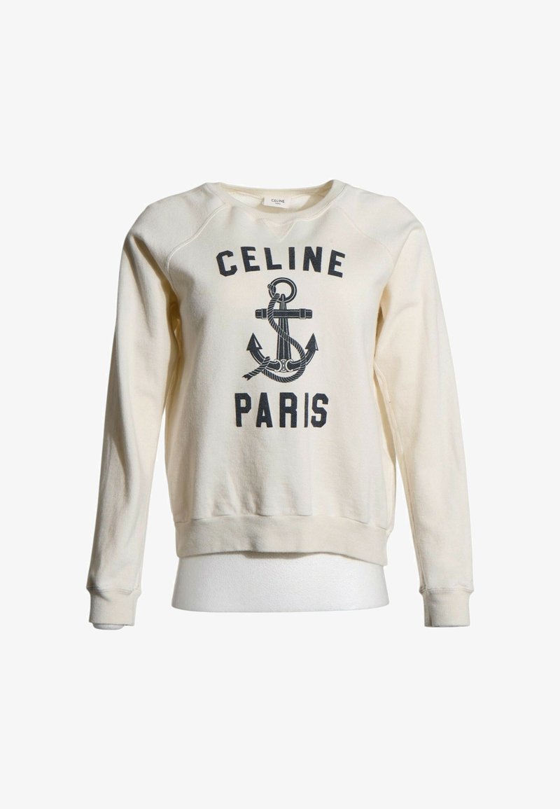 Sweat-shirt à manches longues couleur crème avec graphique d'ancre noire et texte "CELINE PARIS" sur le devant.