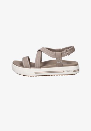 Beige casual sandal with adjustable straps, cushioned sole, and white rubber outsole designed for comfort and support.