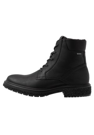 Sort læder ankelstøvle med snørelukning foran, tekstureret gummisål, polstret krave og et lille Gore-Tex mærke i siden.