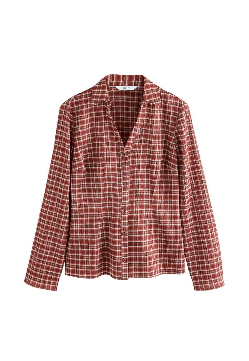 Chemise à manches longues à carreaux rouges et blancs avec un col, fermeture à boutons et tissu doux et léger.