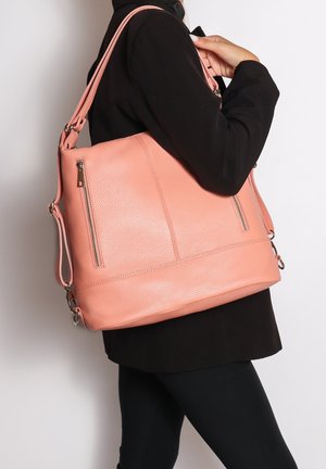 Perzikkleurige lederen totebag met dubbele zijritsen, verstelbare schouderbanden en een ruime indeling. Bevat subtiele stiksels.