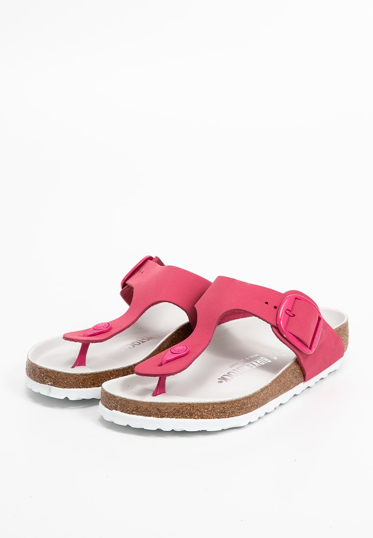 Rosa Gummisandalen mit Korkfußbett, verstellbarem Schnallenriemen und weißer Laufsohle. Glatte Textur und minimalistisches Design.