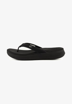 Black flip-flop sandal with a flexible rubber sole and thin straps; the sole features a slight elevation for comfort. Reinforced hardware visible.