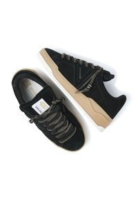 Black suede sneakers with textured laces, beige rubber sole, and contrasting white midsole; features a geometric design on the side.