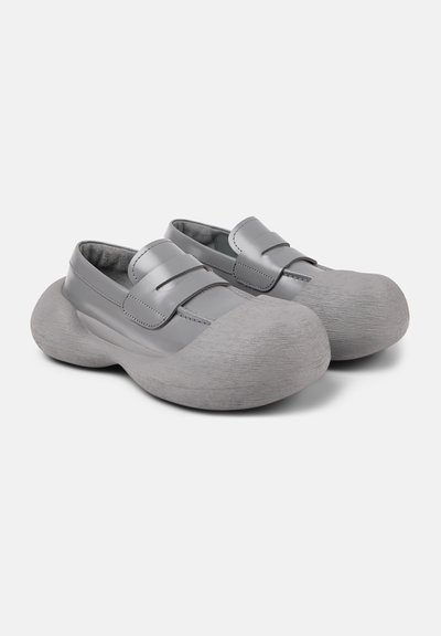 Gray shoes with a textured rounded sole, smooth upper with straps, and a padded interior. Lightweight design, modern shape.