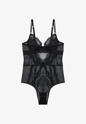 Body en dentelle noire avec bretelles doubles réglables, bonnets avec armatures, panneaux en maille transparente et fermetures pression à l’entrejambe.
