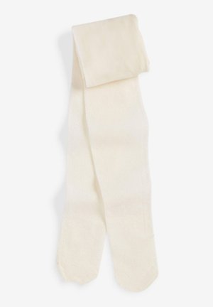 Beige pantyvoorkeurs gemaakt van zacht materiaal; heeft een gladde textuur met een lichte glans, naadloos afgewerkt met een ronde teen.