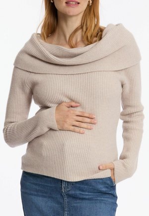 Pull en maille côtelée beige clair avec un large col drapé et des manches longues. Tissu texturé, silouhette ajustée et subtiles rayures horizontales.