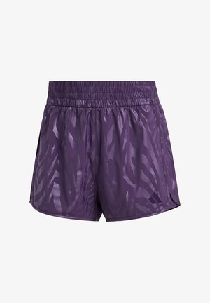 Ljubičaste hlače sa vezicama napravljene od glatkog, laganog materijala s suptilnim uzorkom zebre i bočnim prorezima za veću pokretljivost.