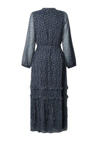 Longue robe bleu marine avec petit imprimé floral blanc, manches longues transparentes, taille cintrée et jupe à volants, vue de dos.