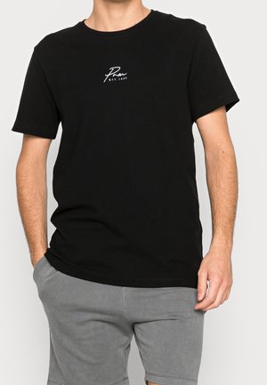 Black cotton t-shirt with short sleeves, crew neck, and a small white logo on the chest. Texture appears smooth and soft.