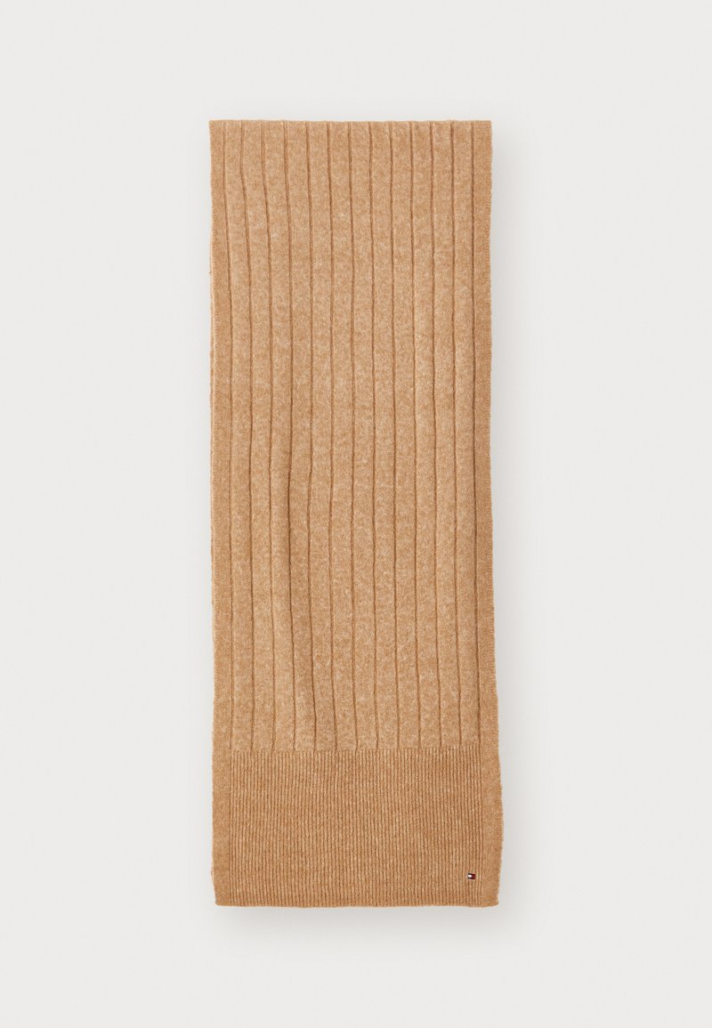 Ribbed beige scarf made from textured material, featuring a wider ribbed knit at the ends and a small logo detail in the corner.