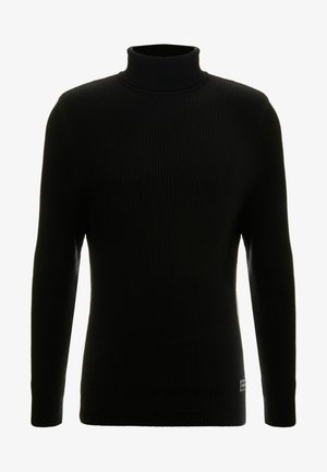 Sort turtleneck sweater med lange ærmer, ribbet tekstur, tætsiddende silhuet og lille mærke nederst til venstre.