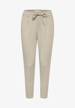 Smėlio spalvos sportiniai keliai, pagaminti iš minkštos medžiagos, su elastingu juosmeniu ir raišteliu, dviem priekinėmis kišenėmis ir siaurėjančio silueto dizainu.