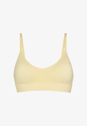 Reggiseno wireless beige morbido con spalline sottili regolabili e una fascia ampia sotto il busto, progettato per comfort e supporto leggero.