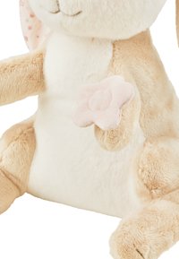 Soft beige plush rabbit with a white belly, pink flower accent on its paw, and patterned ears. Features rounded shapes and textured fur.