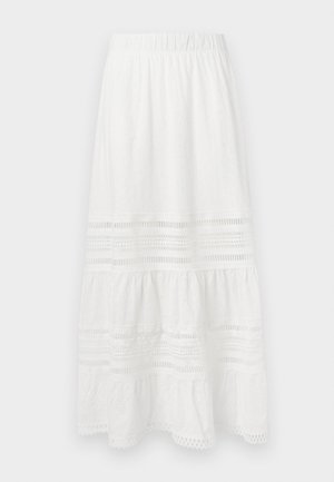 Baltā kokvilnas maksi svārki ar acu audumu, vairāku līmeņu dizainu, elastīgu jostu un mežģīņu akcentiem gar apakšējo malu un paneļiem.