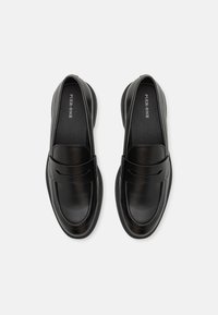 Black leather loafers with a smooth finish, rounded toe, and subtle stitching details. Cushioned insole for comfort.