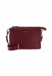 Small maroon leather crossbody bag with adjustable fabric strap and silver zipper, featuring a front logo in silver metal letters.