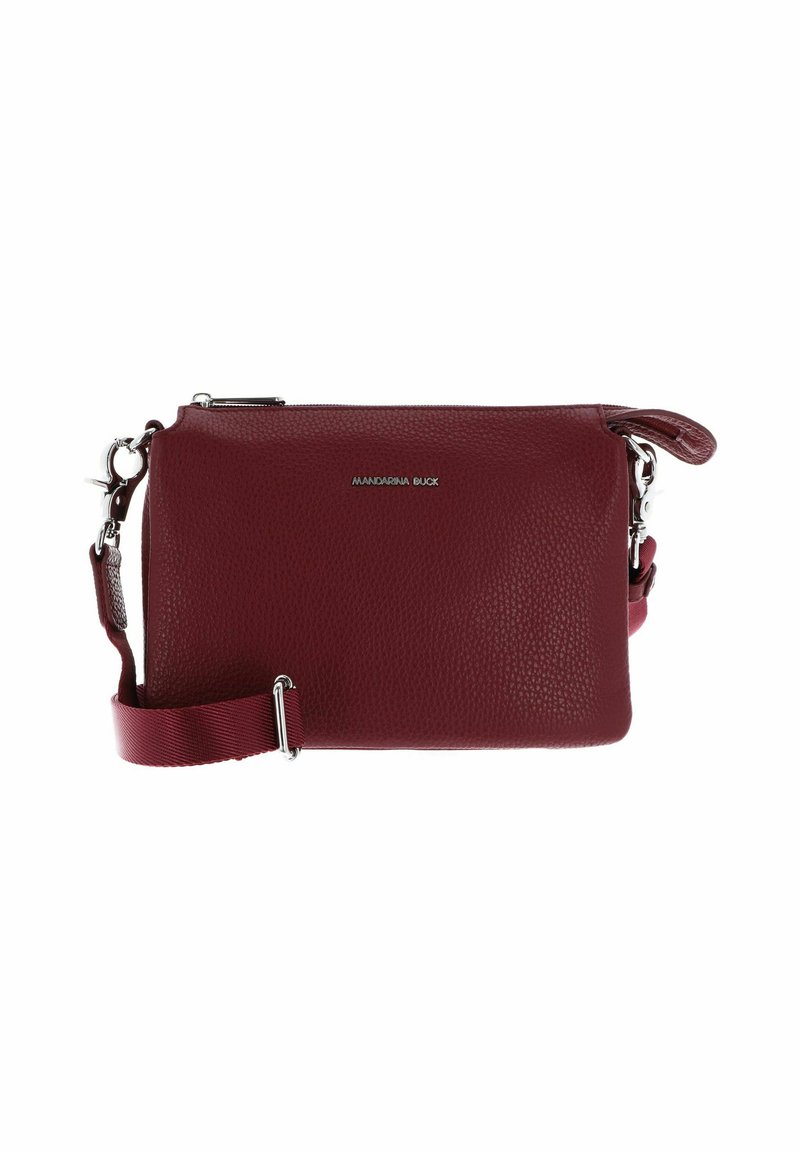 Small maroon leather crossbody bag with adjustable fabric strap and silver zipper, featuring a front logo in silver metal letters.