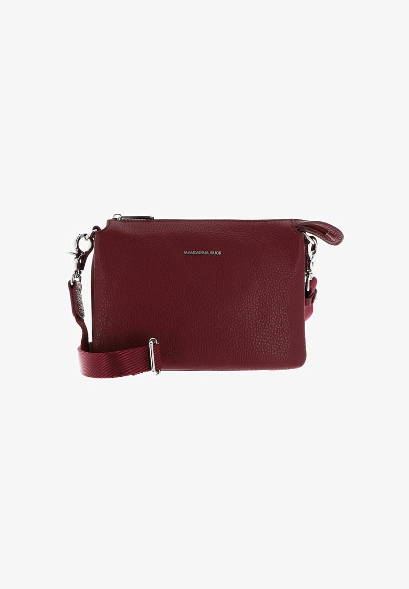 Small maroon leather crossbody bag with adjustable fabric strap and silver zipper, featuring a front logo in silver metal letters.