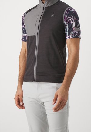 Kurzarm-Radtrikot in Dunkelgrau mit gemusterten Ärmeln in Lila und Pink. Verfügt über einen Frontreißverschluss und eine Reißverschlusstasche.
