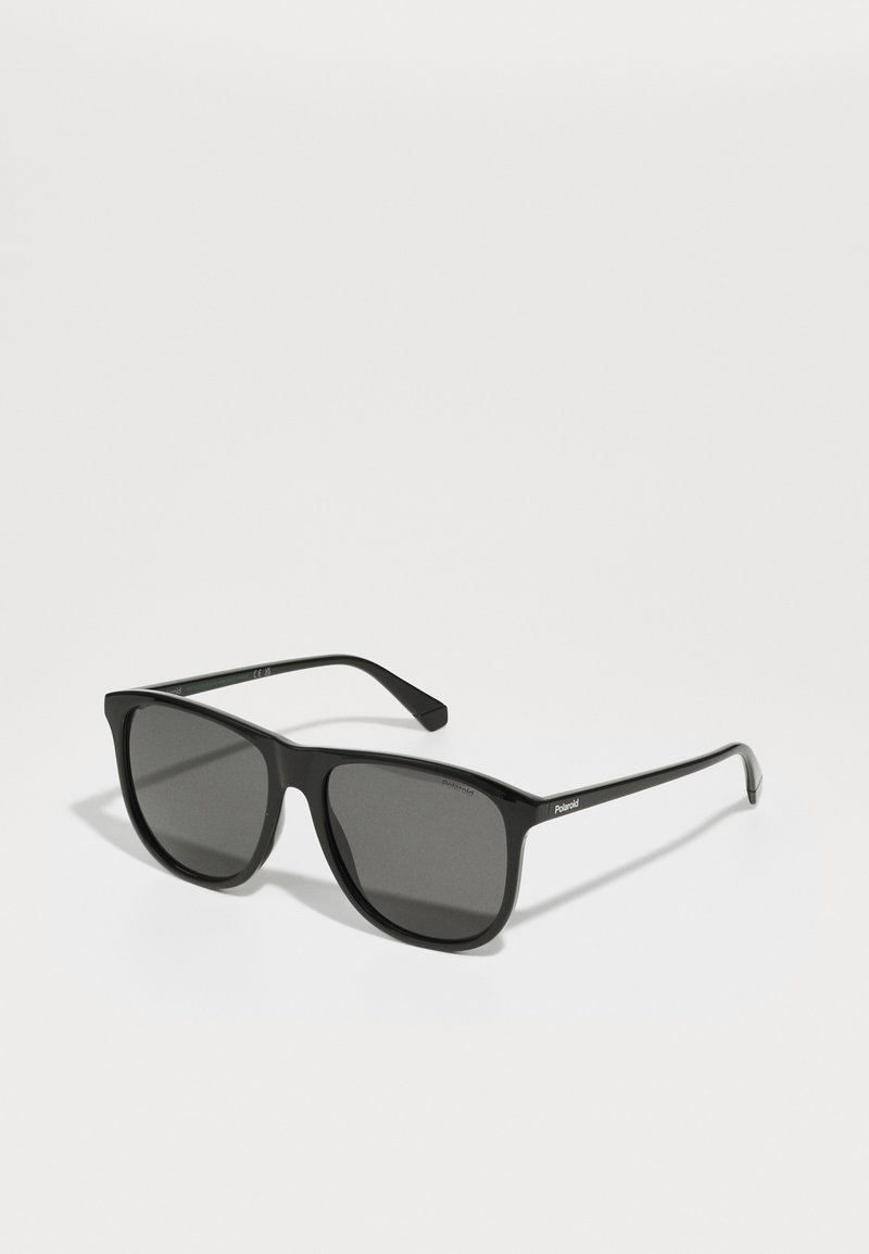 Ochelari de soare negri cu o ramă rectangulară, lentile întunecate și brațe subțiri. Poartă numele mărcii "Polaroid" pe lateral.