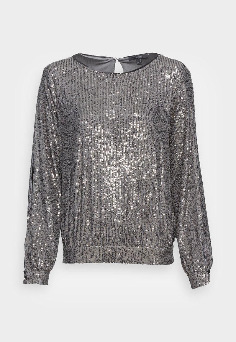 Haut à manches longues en sequins argentés avec un col rond et une fermeture en forme de clé au dos. Présente des poignets élastiques et un bord inférieur élastique, créant un aspect texturé.