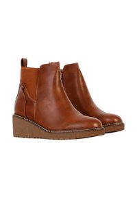 Bottes basses en cuir marron avec une semelle compensée, une fermeture éclair latérale, un panneau élastique et une semelle en caoutchouc texturée. Finition lisse avec des détails de couture subtils.