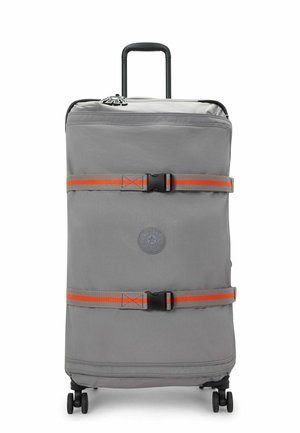 Gray rolling suitcase with a logo, orange accents, two securing straps, and a retractable handle. Smooth texture and four wheels for mobility.