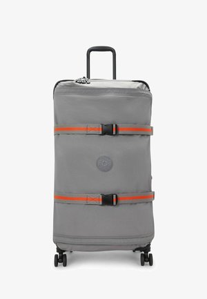 Gray rolling suitcase with a logo, orange accents, two securing straps, and a retractable handle. Smooth texture and four wheels for mobility.
