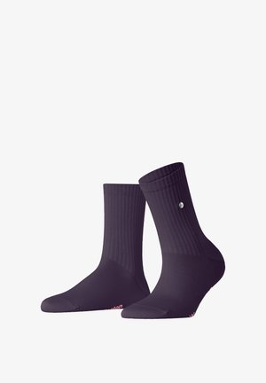 Chaussettes en coton violettes à motif côtelé, hauteur cheville. Présentent un petit logo sur le côté et une marque rose au niveau des orteils.
