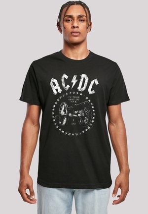 Schwarzes Baumwoll-T-Shirt mit einem gealterten AC/DC-Logo und Kanonengrafik mit Sternen, das ein mutiges, grafisches Design schafft. Kurze Ärmel, Rundhalsausschnitt.