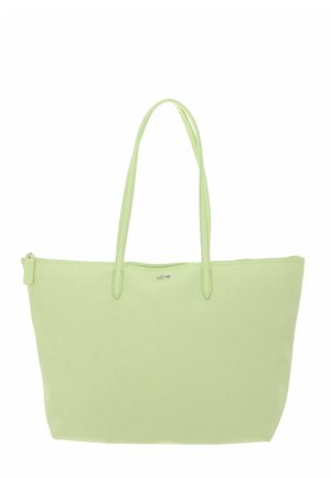 Sac cabas vert clair avec deux longues poignées, fermeture éclair sur le dessus et petit logo argenté au centre avant.