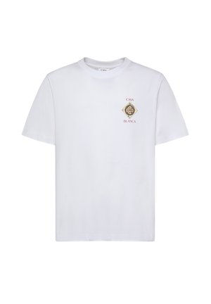Witte T-shirt met ronde hals en korte mouwen, met een klein decoratief embleem op de borst met de tekst "Casa Blanca" en een gouden cirkelvormig ontwerp.