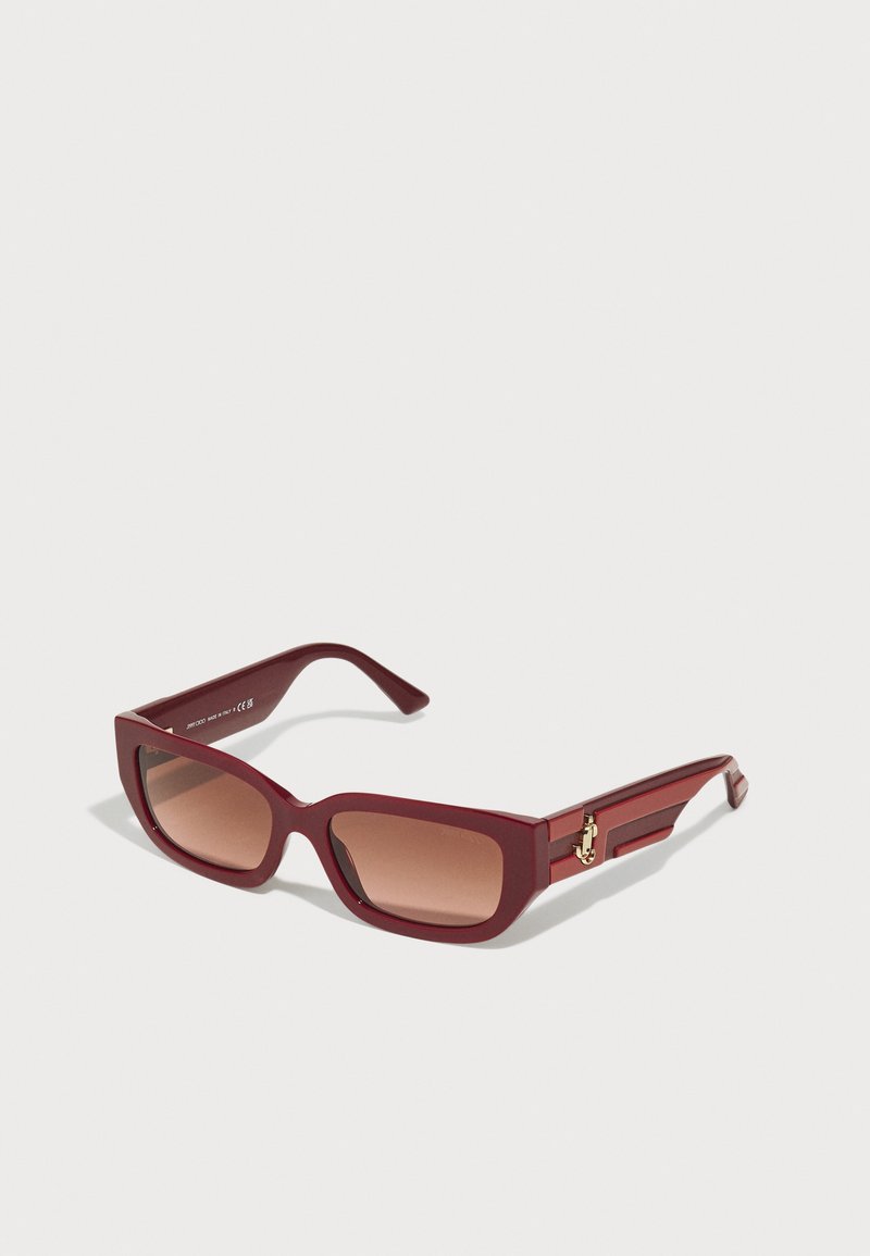 Maroon rectangular sunglasses with gradient brown lenses, thick plastic frames, and gold hardware accents on the sides.