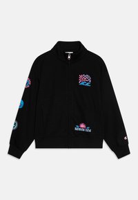 Veste zippée noire en tissu doux, ornée de motifs colorés sur la poitrine et les manches, incluant des vagues et des motifs de soleil.
