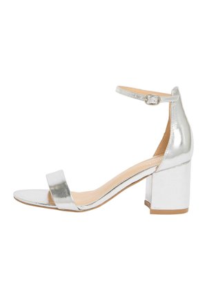 Silberne, metallische Sandale mit offenem Zehenbereich, Blockabsatz und Knöchelriemen mit kleiner Schnallenschließe.