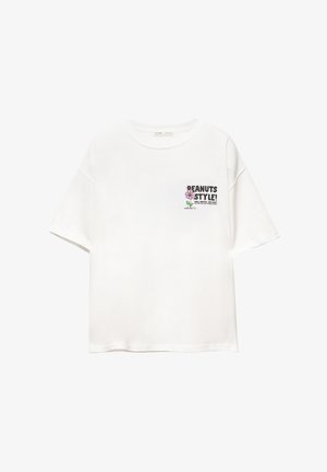 T-shirt bianco in cotone con una vestibilità rilassata, caratterizzata da un design stampato "PEANUTS STYLE!" in nero e rosa sulla parte sinistra del petto.