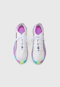 White athletic shoes with a colorful tie-dye pattern on the sole, featuring a breathable upper, lace closure, and logo accents.