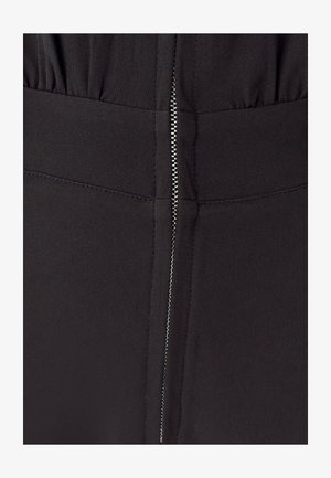 Black fabric garment featuring a hidden zipper closure at the back, with gathered detailing and smooth texture. Simple, sleek design.