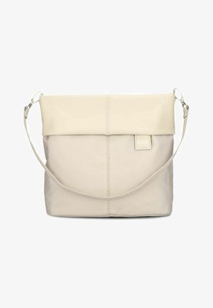 Beige fabric and leather crossbody bag with a fold-over top flap and adjustable strap, featuring subtle stitching and a small tag.