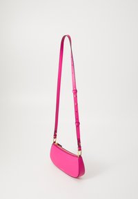 Pink leather shoulder bag with a long, adjustable strap. Features a zip closure and a smooth, slightly textured finish. Rectangular shape.