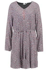 Robe à manches longues avec décolleté en V, dotée d'un col zippé et d'un motif floral rouge, bleu et blanc sur un fond gris.