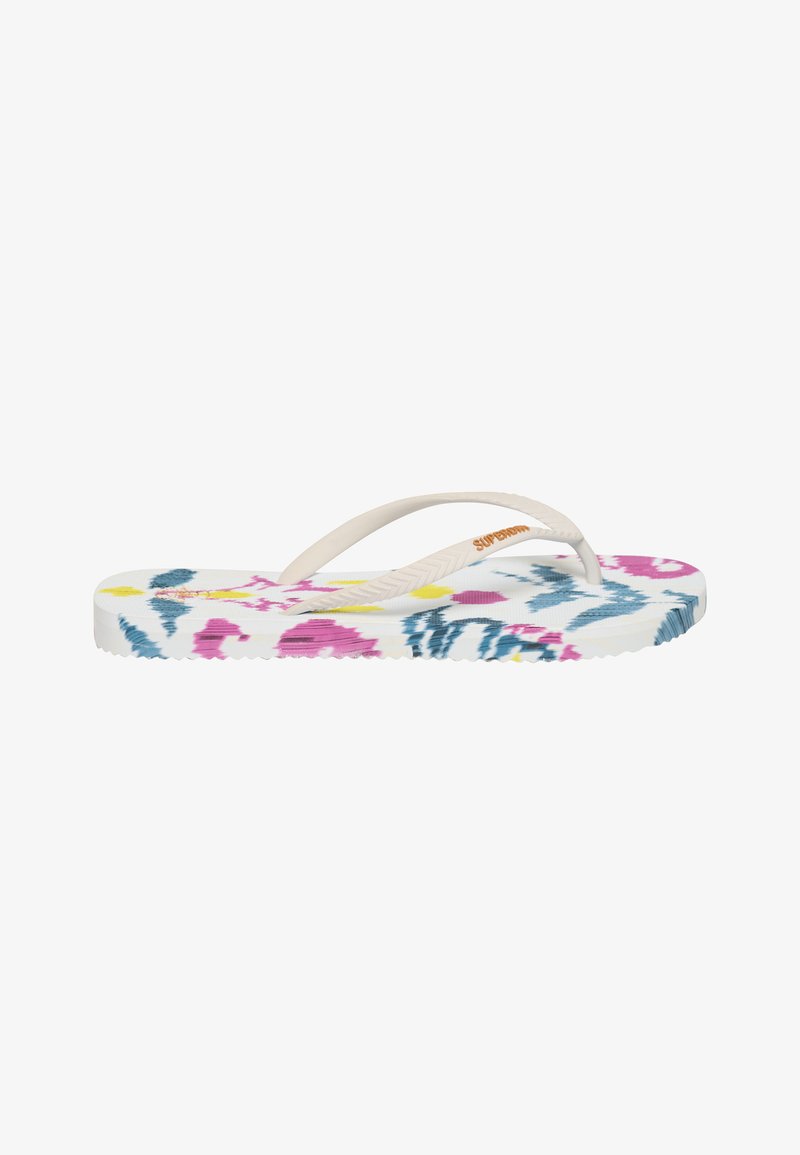 Sandale tongs blanche avec des brides beiges et un imprimé floral abstrait multicolore sur la semelle, vue de profil sur fond blanc.