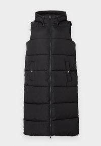Melnās pūkainās veste ar kapuci, ar rāvējslēdzēju priekšpusē un sānu kabatām. Tam ir quilted tekstūra un regulējami auklas kapuces priekšā.