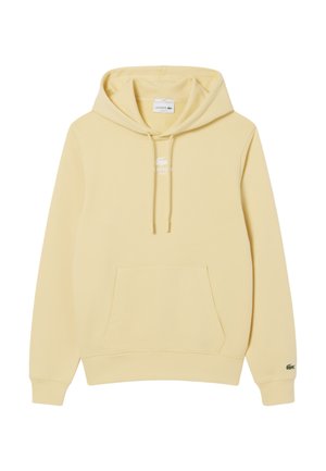 Felpa gialla con cappuccio, realizzata in tessuto morbido, con tasca frontale, coulisse e un piccolo logo bianco di Lacoste sul petto.