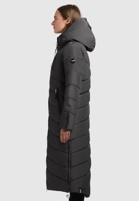 Long black puffer coat with a hood, featuring horizontal stitching, zippered pockets, and a slightly tapered silhouette. Smooth, shiny texture.